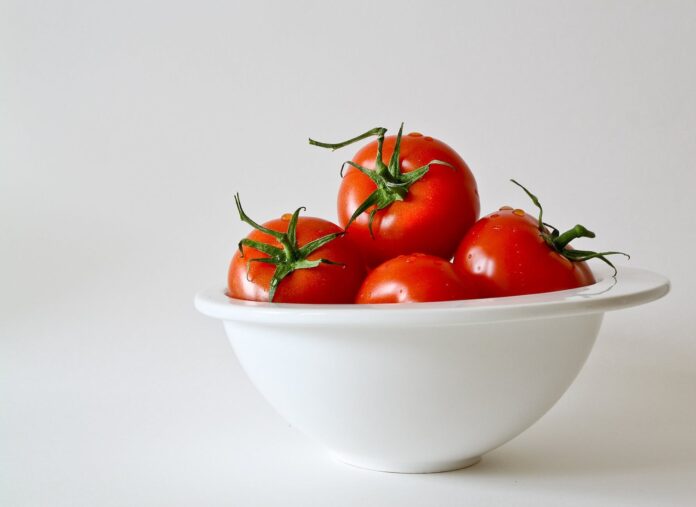 red tomatoes in white bowl